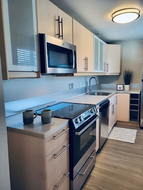 a kitchen with a stove top oven next to a sink